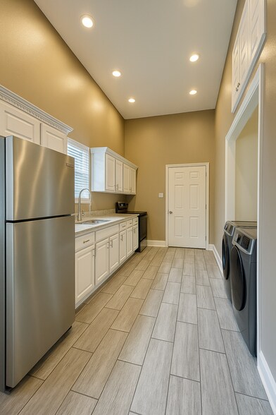 Kitchen with refrigerator and gas stove. - 2621 1st St