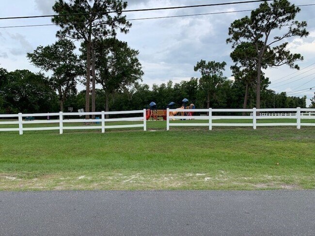 Building Photo - Available NOW! NEW FLOORS AND PAINT! Lovely 3/2 in Poinciana! HUGE fenced yard and NO CARPET!