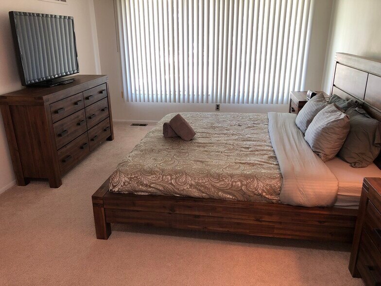 Spacious upstairs bedroom features delux king bed, walk in closet and 42" TV - 8328 Karam Blvd