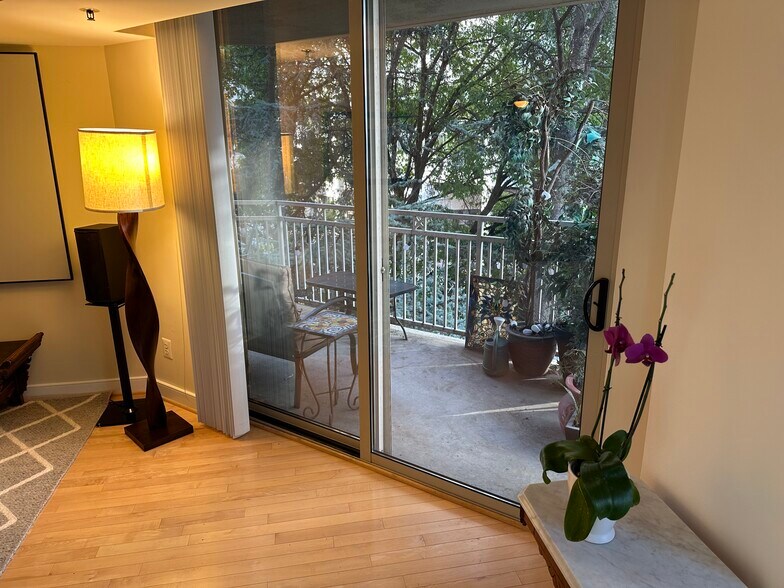 living room and view of balcony - 7500 Woodmont Ave