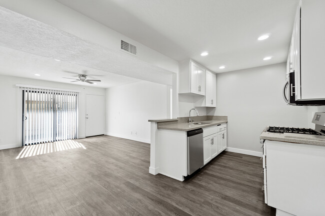 Plank flooring, central air, and patio off living room - Whitaker Terrace Apartments