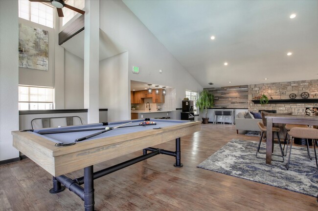 Image of the spacious resident club house with a billiards table, and wood-style plank flooring. - Chestnut Ridge Apartment Homes