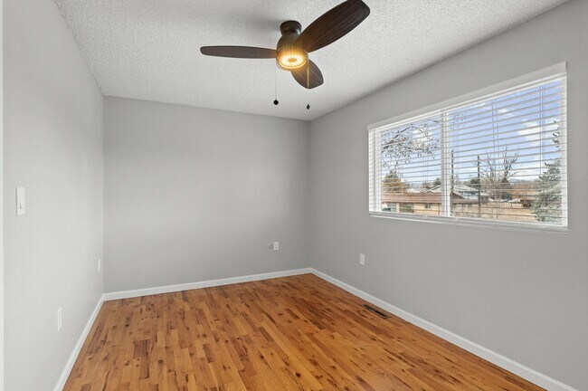 Experience comfort in this bright bedroom, perfect for relaxation and tranquility. - 5580 West 4th Avenue Townhomes