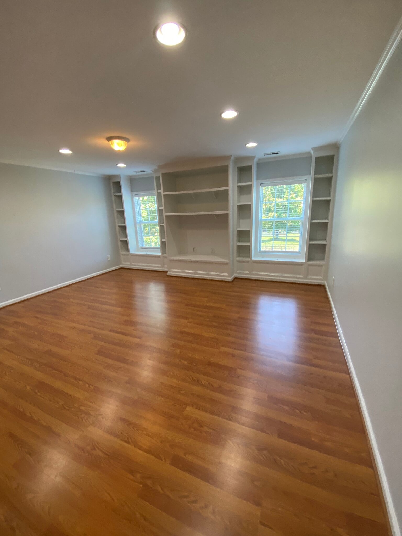 upstairs bonus room with space form storage and entertainment system - 10102 Glenburn Ln