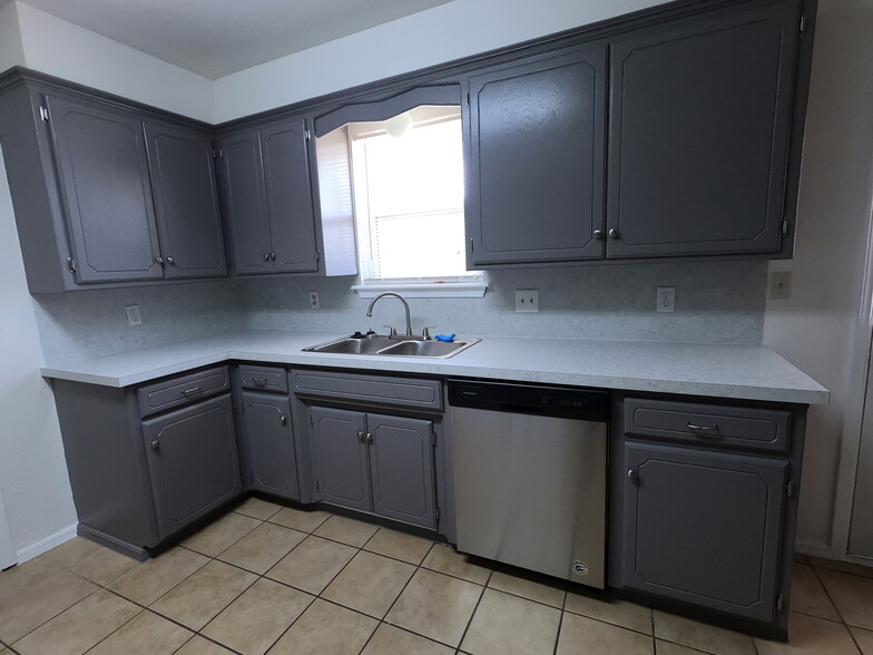 North side of kitchen - new dishwasher, sink, faucet, countertops, freshly painted cabinets with new hardware and hinges - 415 W Guthrie St