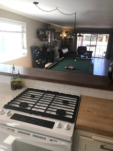 New stove, butcher block, and opens to the dining area - 1335 Newport Ave