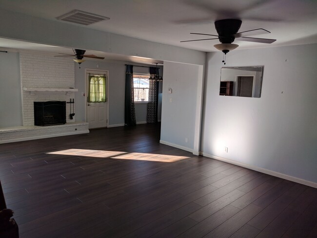 Living room with fireplace and ceiling fans - 8716 E 47th Pl