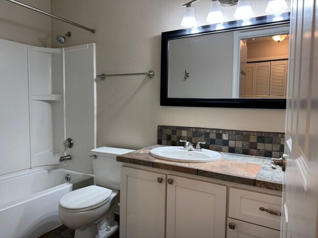 Building Photo - Serene Ground-Floor Condo Overlooking Green Space – Parking Included