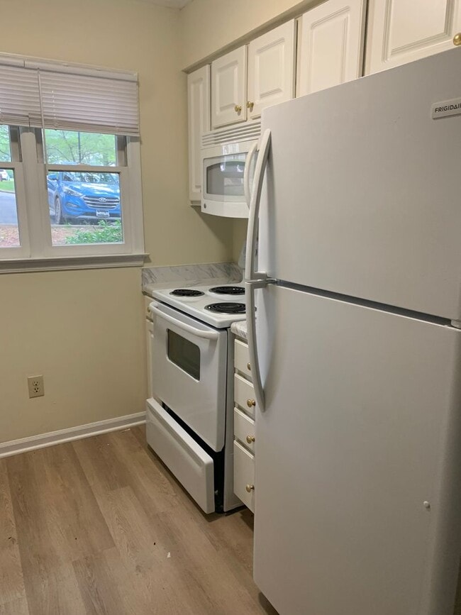 Building Photo - ONE LEVEL CONDO NEAR REX HOSPITAL -Firepla...