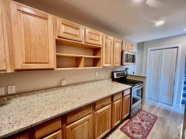 Kitchen facing West, view of doors to downstairs, new quartz countertops - 1703 Quiver Ct