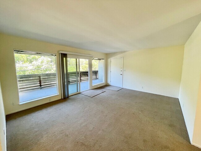 Building Photo - Sunlit 2BD/1BA w/ Private Balcony + Backyard! New Carpet! Assigned Parking! PROGRESSIVE
