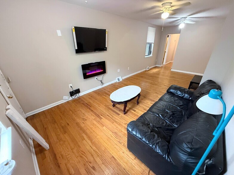 Apt 1 - Living Room comes with TV and Fireplace - 2148 N Carlisle St