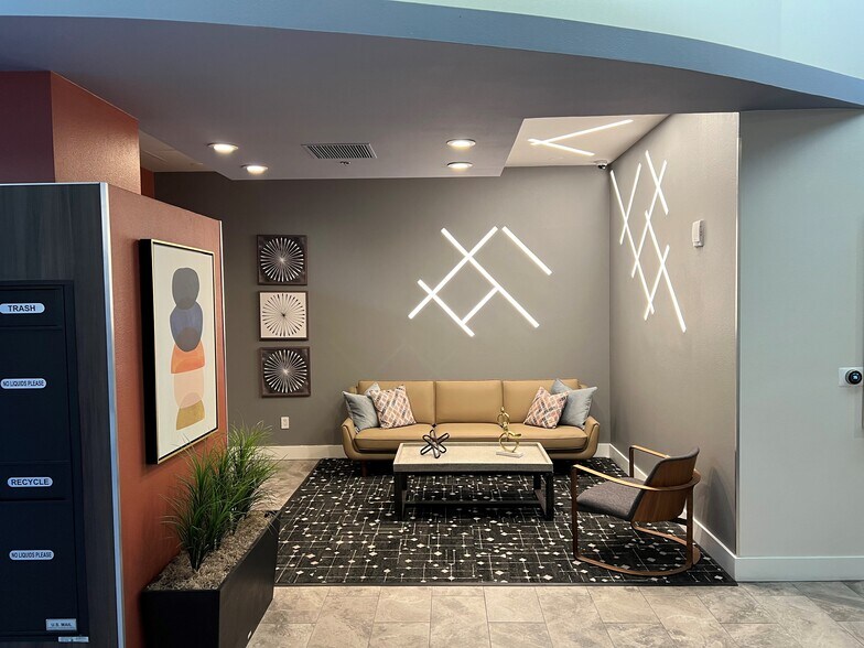 Inviting seating room in lobby adjacent to convenient Amazon lockers. - 427 9th Ave