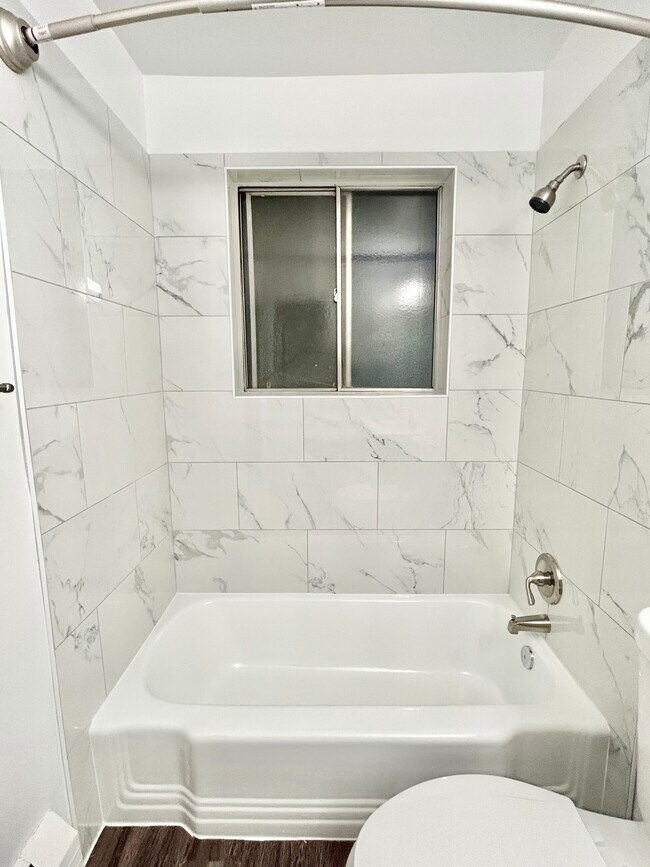 Experience luxury in everyday moments with this stylish marble bathroom. - GRACE LANDINGS APARTMENTS