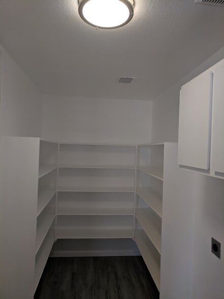Storage shelves in the deep walk in pantry. - 14101 N 78th Dr