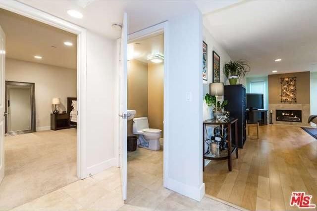 View of entry way to living room, master bedroom and half bath - 1951 N Beachwood Dr