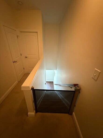 2nd to 3rd floor staircase - doggy / child gate at top - 2615 Stewart Pines Dr