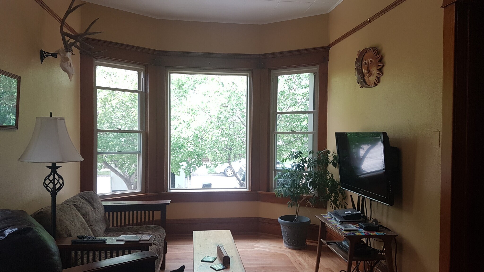 Living room with beautiful bay windows and double pocket doors to the hallway - 407 S. 6th Street