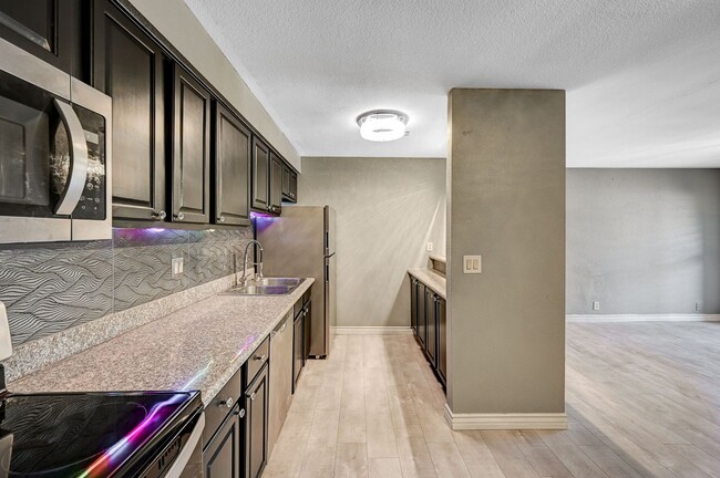 Building Photo - GATED COMMUNITY CONDO WITH BRAND NEW UPGRADES THROUGHOUT