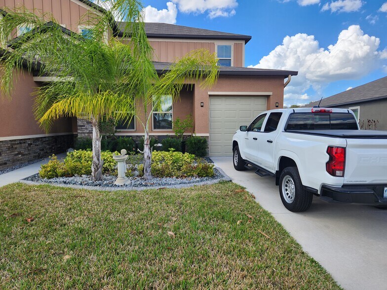 two front windows + 1-car garage & driveway. Front door is left of the windows - 9434 Channing Hill Dr