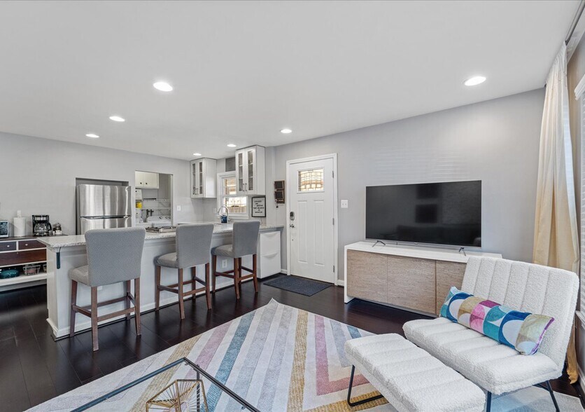 Open concept living room and kitchen with real hardwood floors and updated appliances - 706A W Glebe Rd