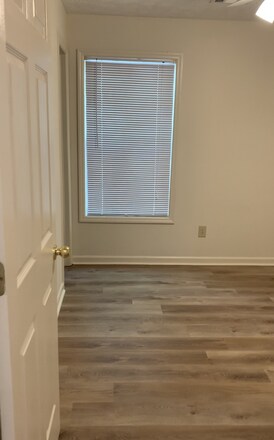 Private bedroom with new flooring and ceiling fan - 535 W Glenn Ave