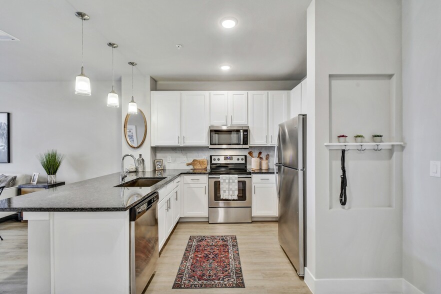 Our gourmet kitchens feature stainless steel appliances. - Windsor Ridge