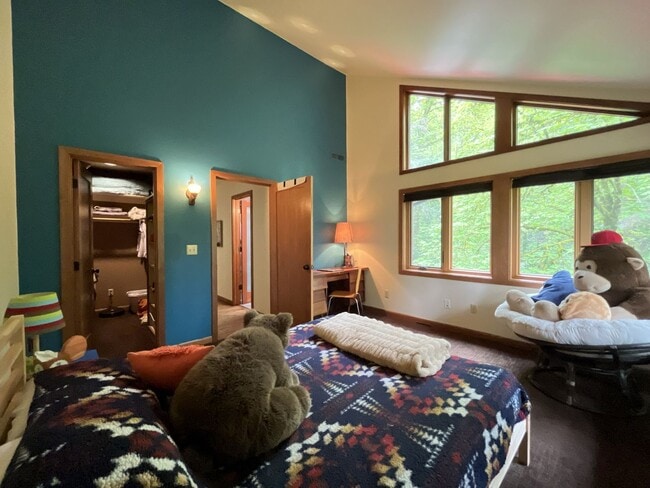 Building Photo - One-of-a-Kind Custom Home with Wall of Windows, Stone Fireplaces, Expansive Entertainment Space &...