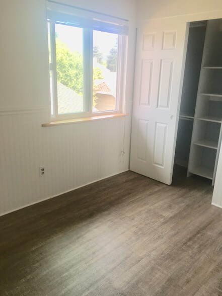 One of the bedrooms. Showing closet and Coretec flooring - 419 Sailfish Dr