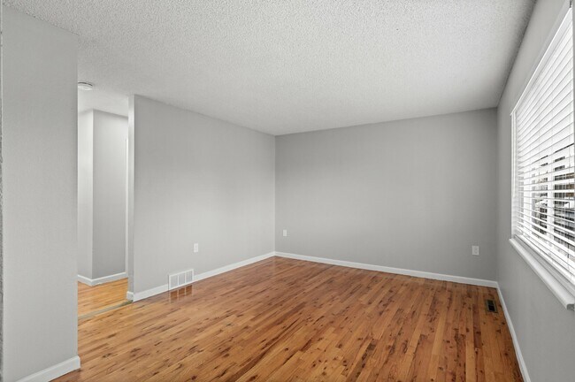 Experience the warmth of natural light in this inviting living room. - 5580 West 4th Avenue Townhomes