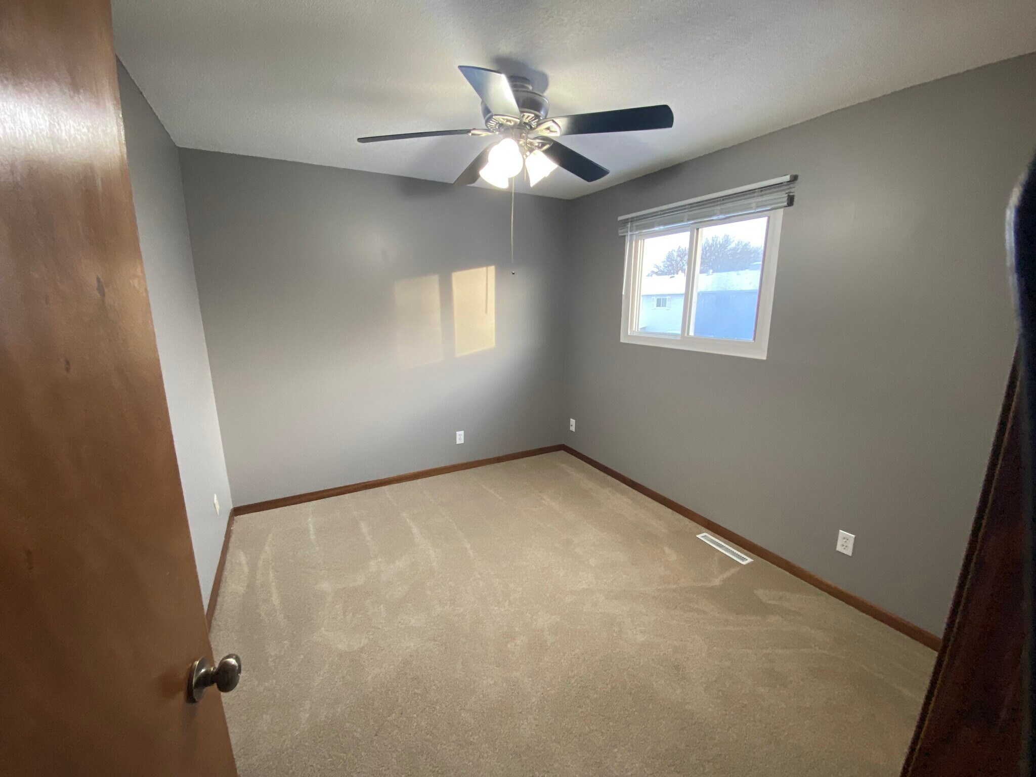 2nd bedroom upstairs with fresh paint and new carpet. - 6387 15th St N