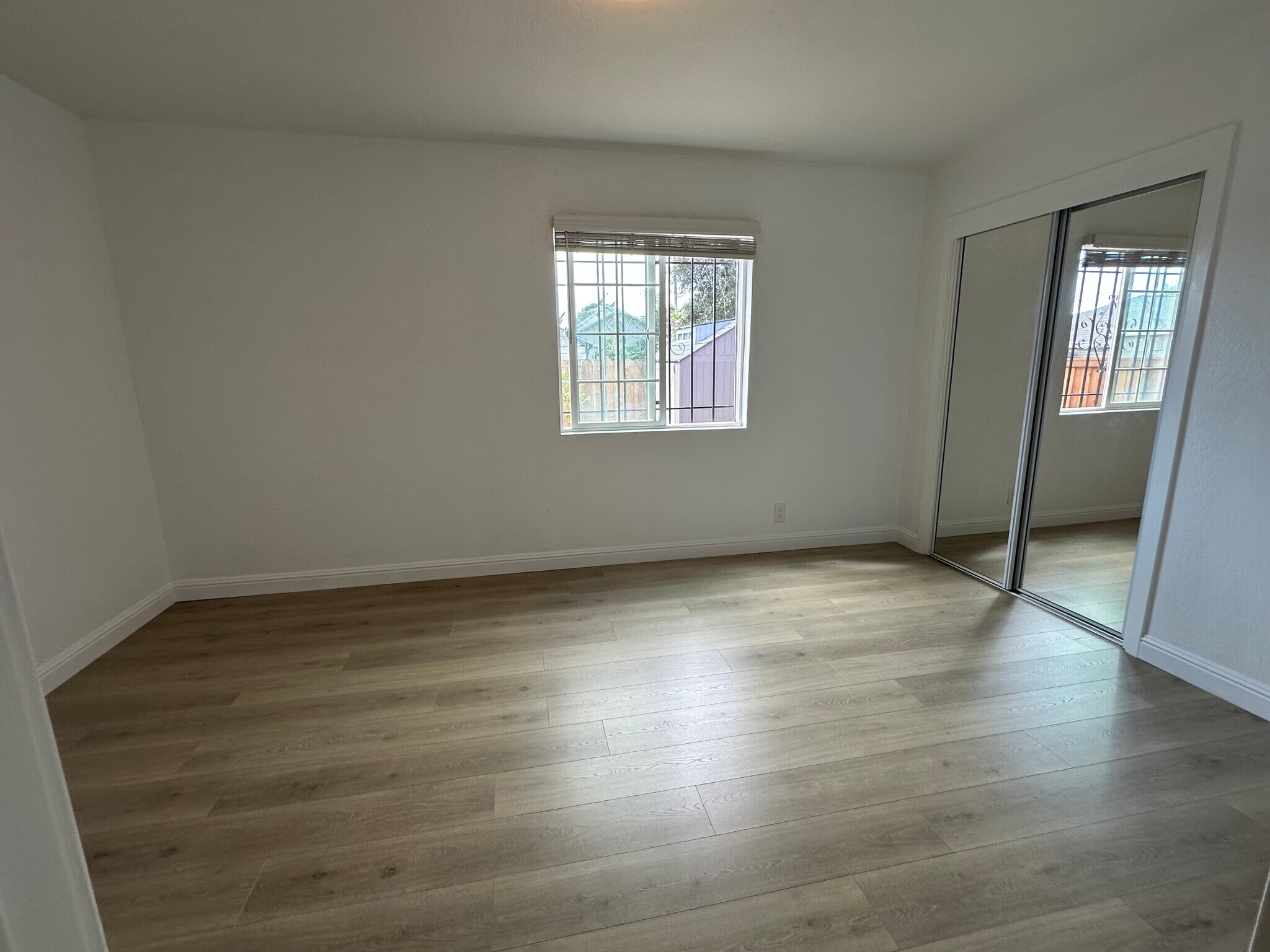 Cozy primary bedroom with natural light and fresh paint. - 721 15th St