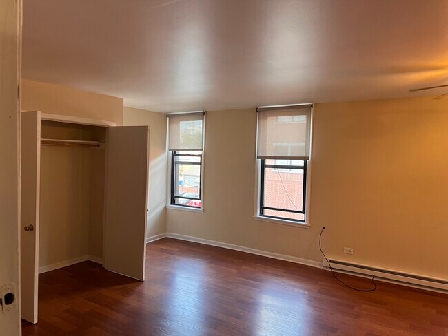 Living Space (2 of 3 windows) Laminate Flooring Throughout. - 7220 Madison St