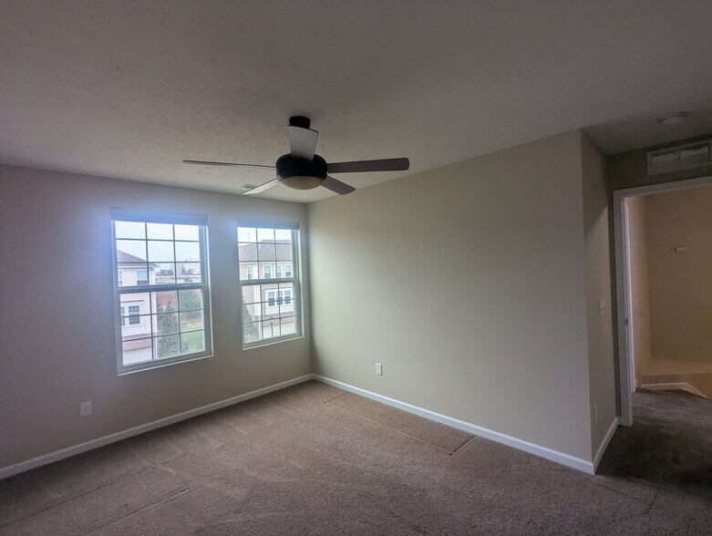 Second bedroom on the second floor features large windows and a spacious closet - 6465 Park Pointe Ct