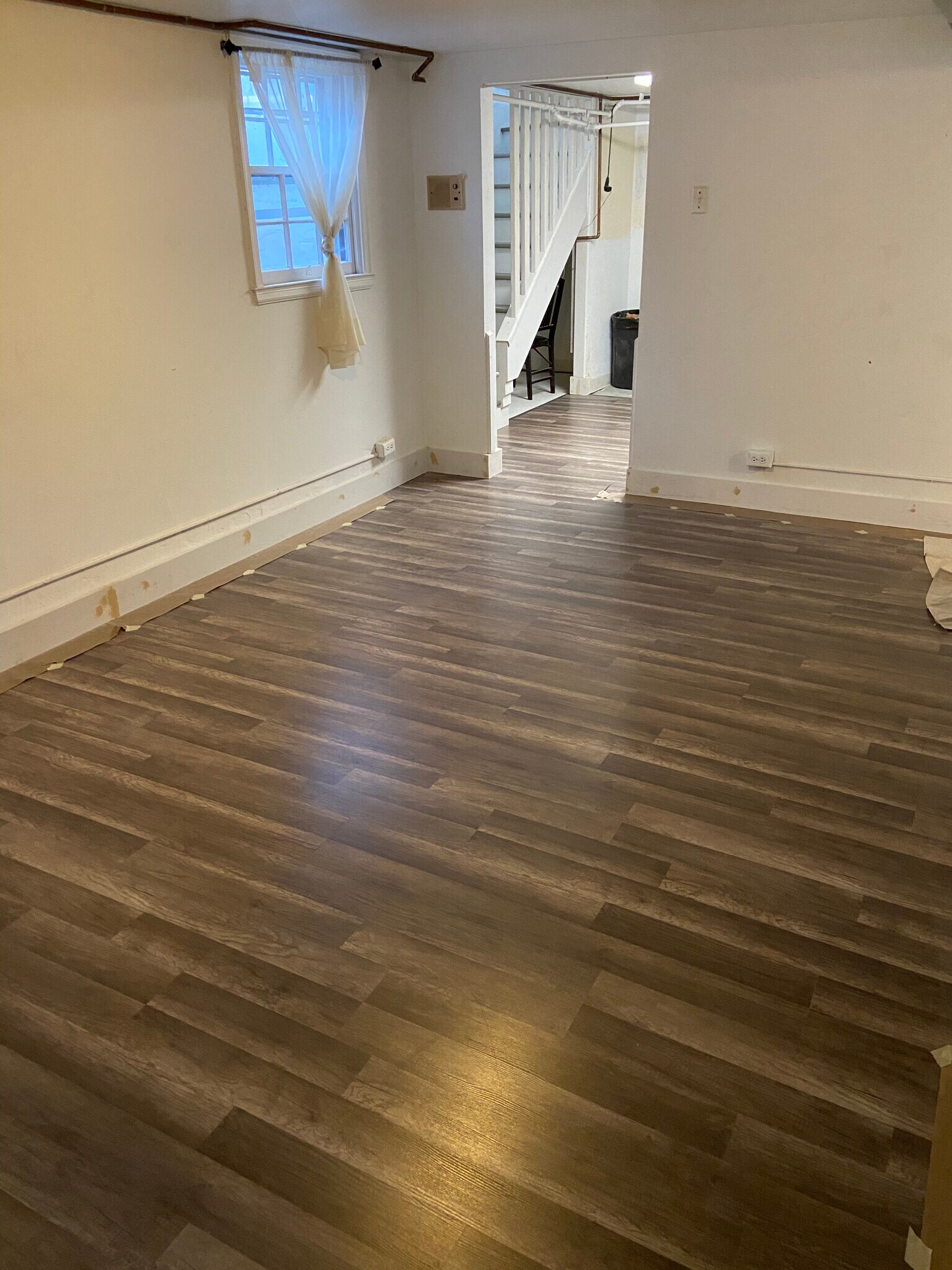 Basement living room with new flooring. - 3131 Milwaukee St