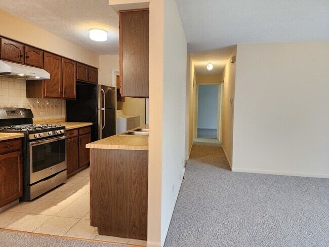 Kitchen with hallway leading to two bedrooms - 326 Plumwood Ln