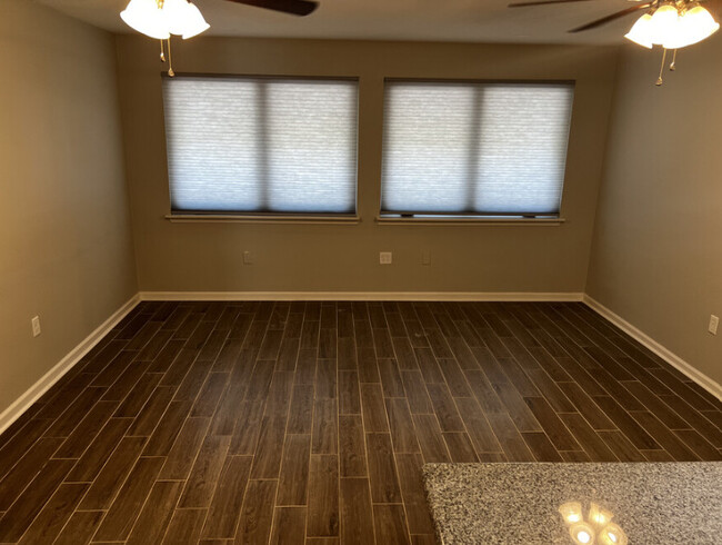 Living room with 2 ceiling fans. - 1012 S Acadian Trwy