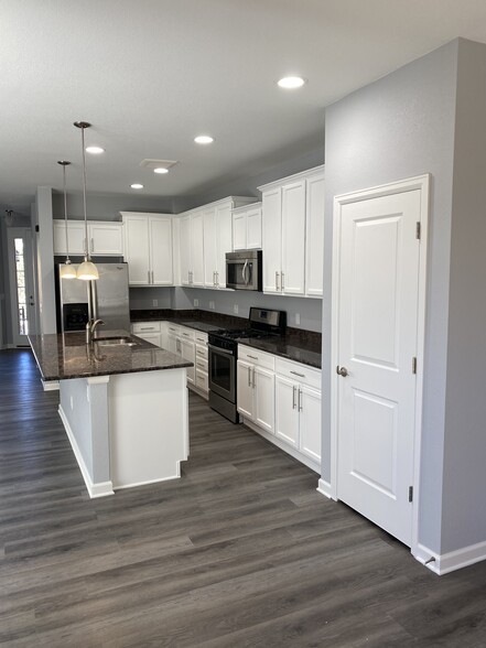 Kitchen with island that seats up to six - 16155 W 62nd Ln