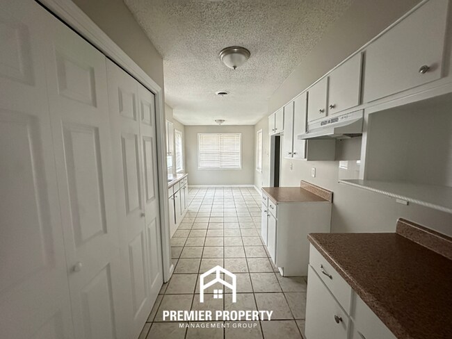 Building Photo - Charming 3BR Memphis Home | Rustic Brick Fireplace, Formal Dining & Fenced Backyard