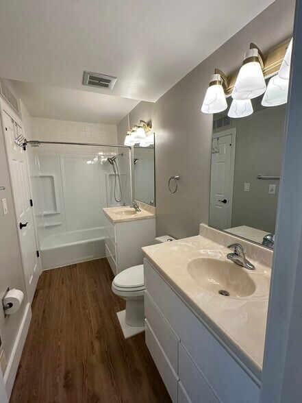 Customized bathroom with two vanities, raised toilet, and bathtub/shower with hand held sprayer. - 2154 Willowgrove Ave