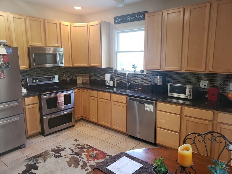 Amazing kitchen, highlighted by tons of cabinets, all stainless-steel appliances, granite countertop, tile backsplash and more - 1809 Stark Drive