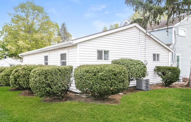 Showing those privacy bushes wrapped all the way around and our AC Unit. - 1902 E Calvert St