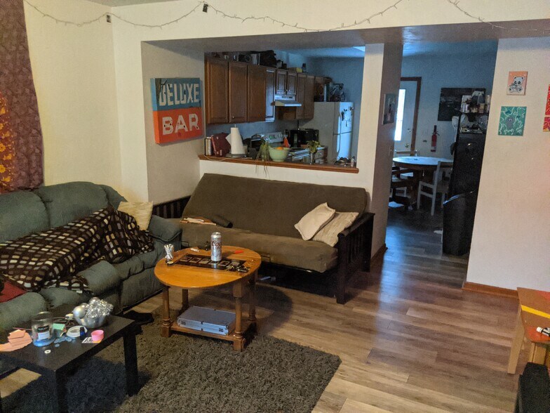 Main floor living room and view into kitchen. - 3239 W Michigan Ave