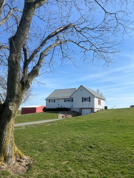 Front of house. Garage and plenty of outdoor parking space. - 203 Reibold Rd