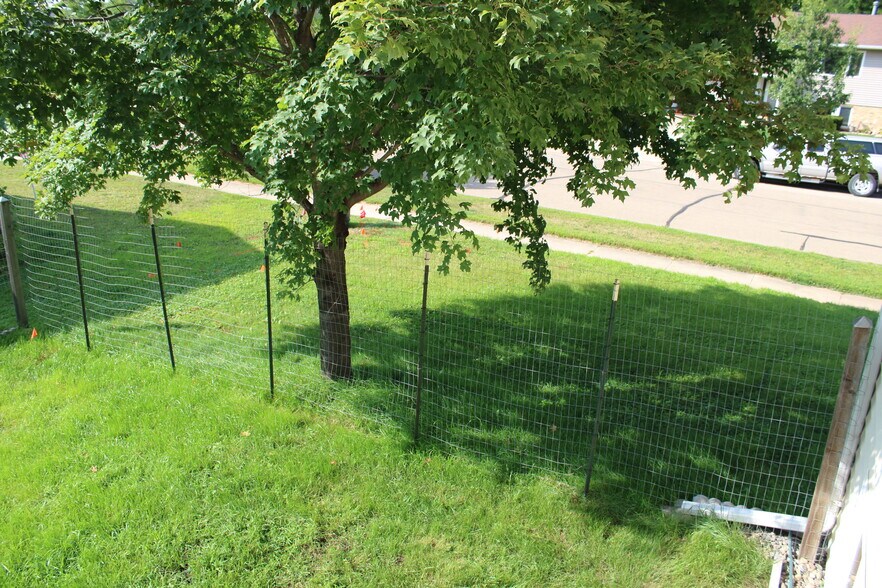 overlooking yard from deck 2. This part of fence will be converted to a cedar fence in the future. - 3991 Whiting Ln NE