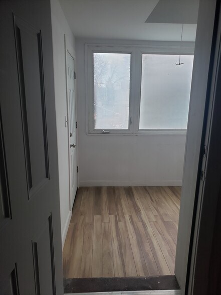 Enclosed porch with hardwood floors - 3811 N Central Park Ave