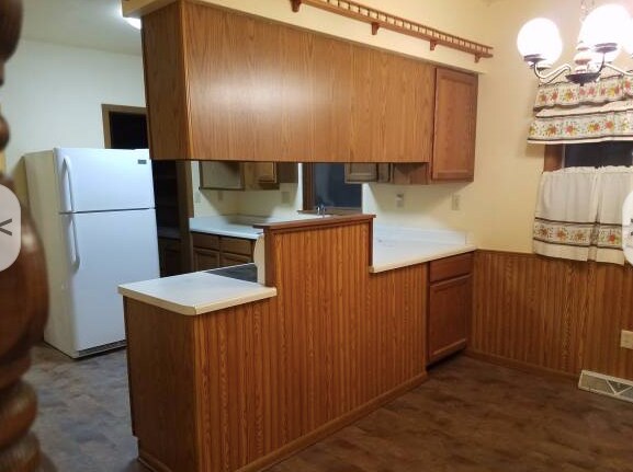 Dining room on the right, can't see all of it. Flooring has been replaced with luxury vinyl planking. New lighter wainscotting. New kitchen counters and new "white" kitchen cabinets. - 1527 South 10th Street