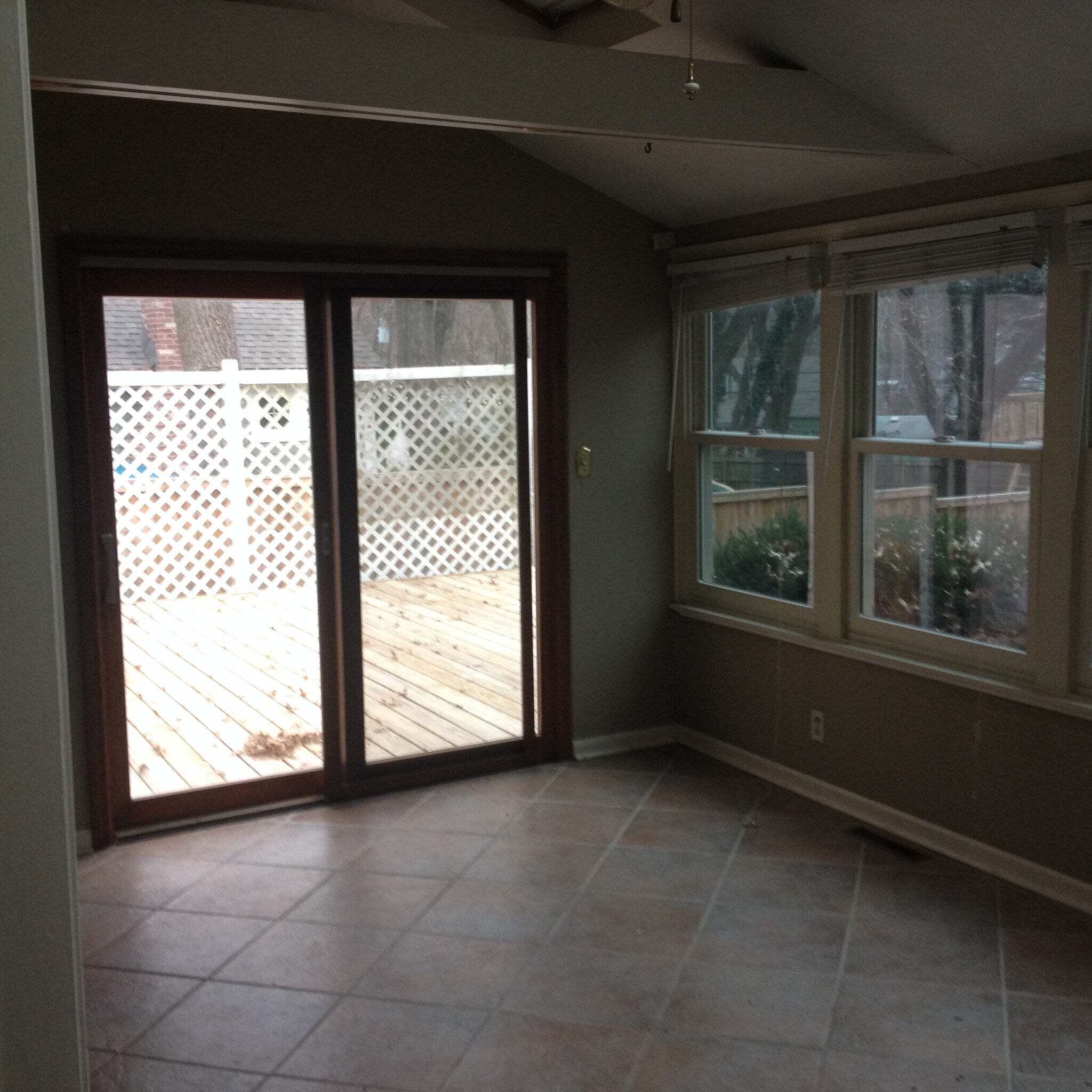 Sunroom lets out to a deck that is slightly above grade in the back yard. - 4515 West 72nd Terrace