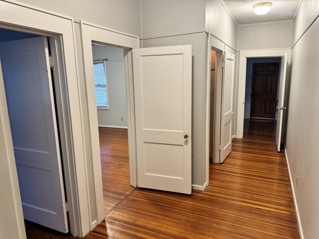 Hallway view into bedroom 2 and living room - 711 W French Pl