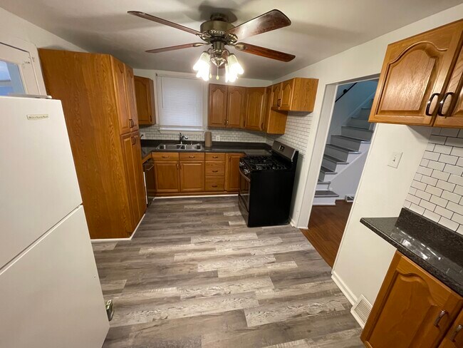 Tons of counter and cabinet space adorn the kitchen. It is large enough to be used as eat in - 212 Lorenz Ave